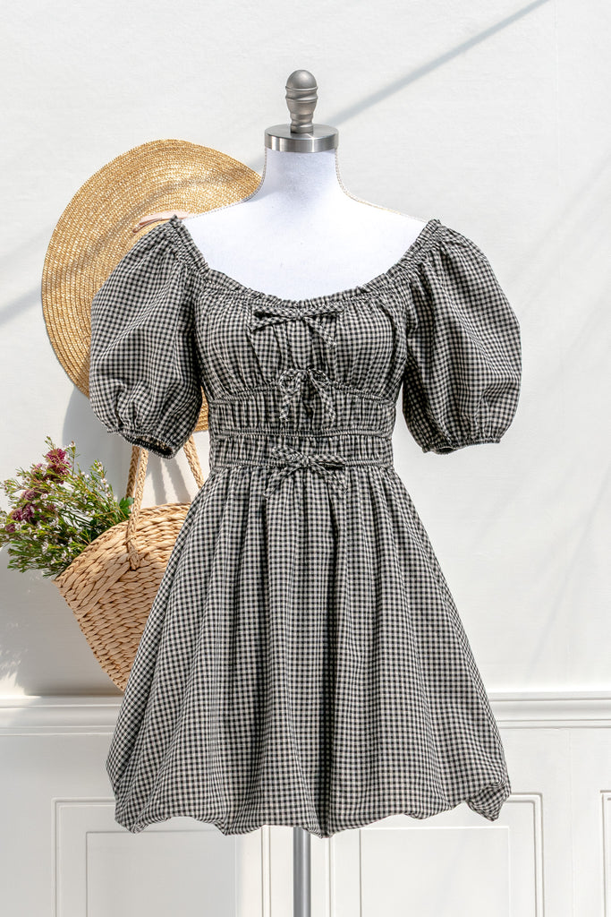 Amantine Lucie gingham mini dress in black and ivory with puff sleeves, sweetheart neckline, and bubble hem — front view