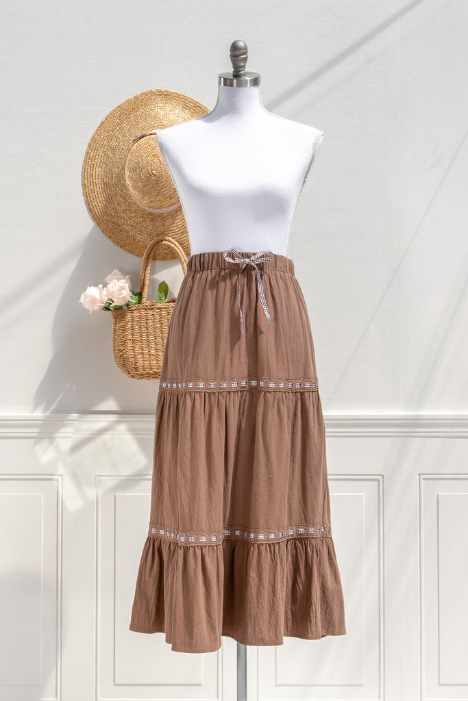 Amantine Luisa tiered cotton midi skirt in chestnut brown with gingham ribbon trim—front view