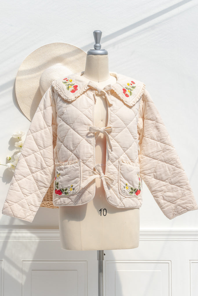Amantine Mari embroidered strawberry quilted jacket in cream with ruffled collar and tie-front — front view
