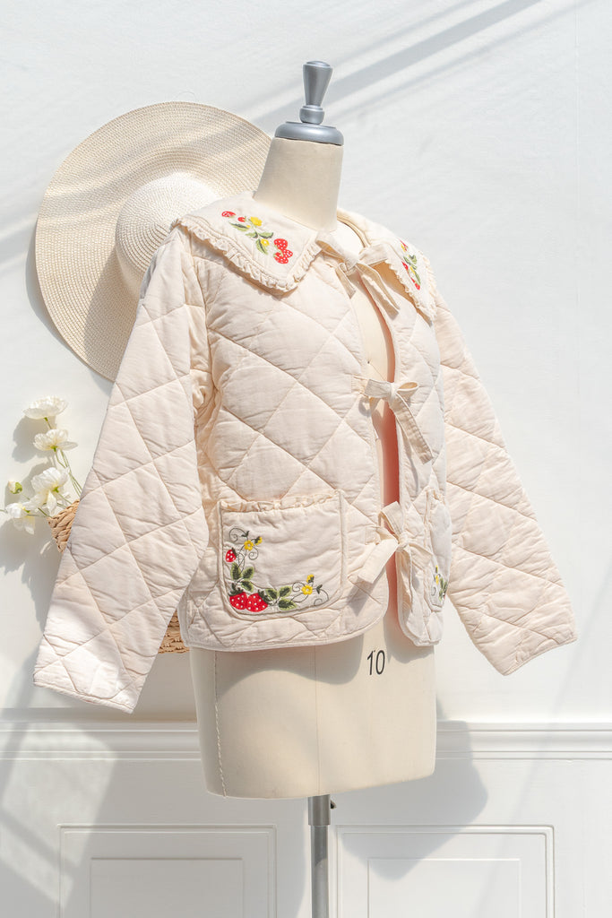 Mari cream quilted jacket — three-quarter view showing embroidered collar, patch pockets, and gentle A-line
