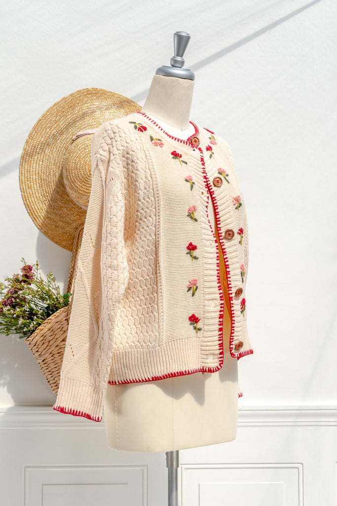 Matilda cream floral-embroidered cardigan — three-quarter view showing red stitched edges and long sleeves
