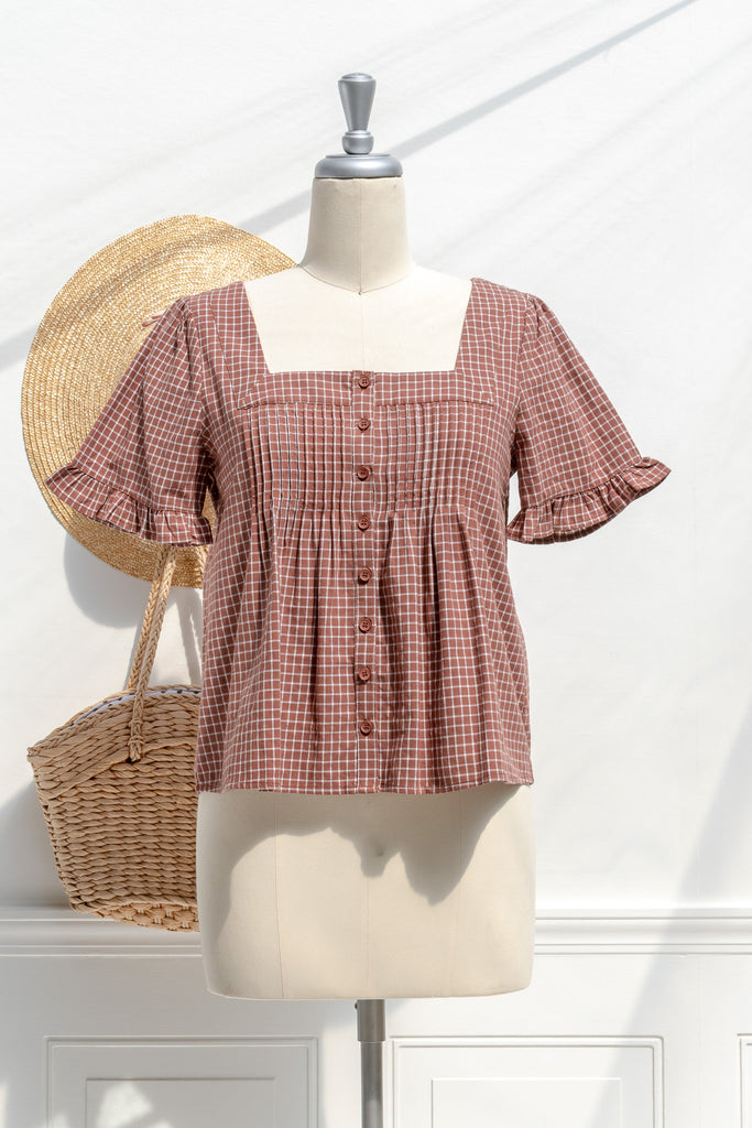 Amantine Mavis cotton babydoll blouse in burnt umber windowpane with square neckline, pintucks, and button front — front view