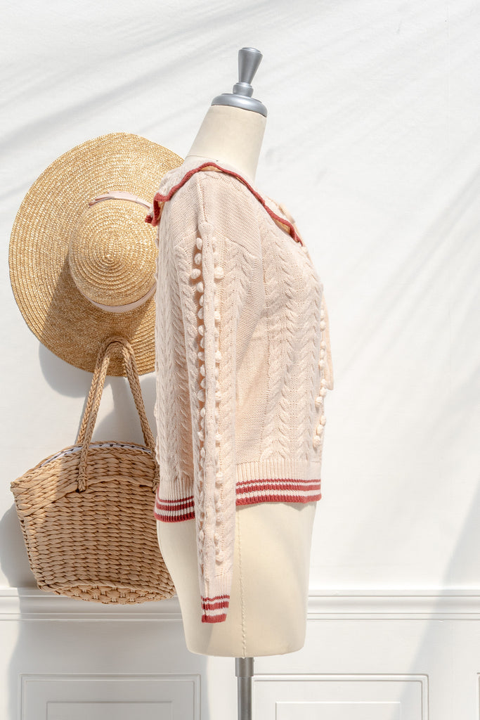Piper cream knit sweater — side view with cable sleeves and cropped hem
