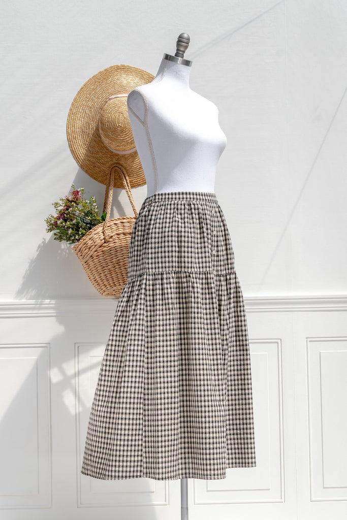 Schoolhouse black/ivory plaid midi skirt — three-quarter view showing button placket and gentle volume