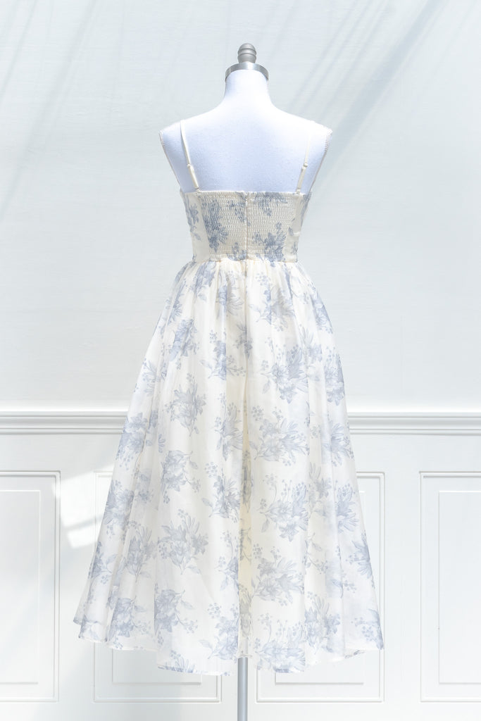 a cute boutique dress -a beautiful blue floral print organza, smocked elastic back, an a-line skirt with petticoat. back view. amantine. 