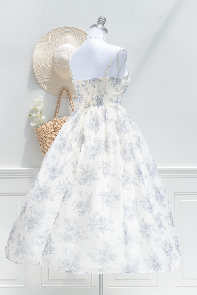 a cute boutique dress -a beautiful blue floral print organza, smocked elastic back, an a-line skirt with petticoat. front view. amantine. 