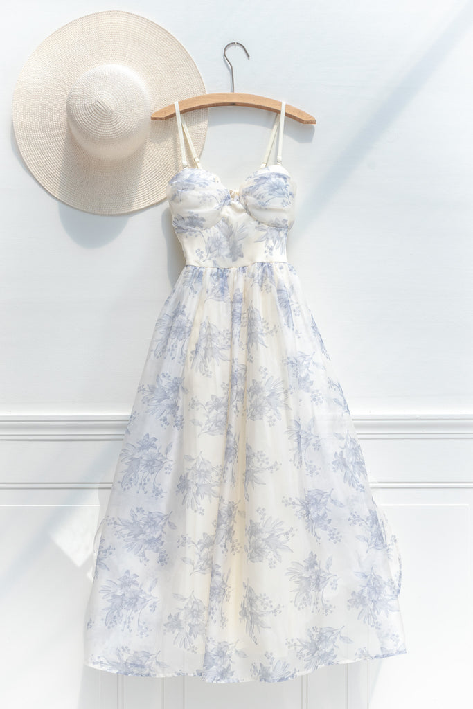 a cute boutique dress -a beautiful blue floral print organza, smocked elastic back, an a-line skirt with petticoat. view on hanger. amantine. 