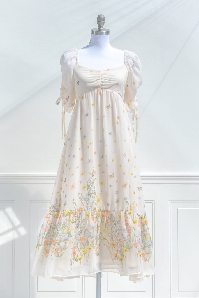 boutique dresses. a beautiful cream floral chiffon midi dress with butterfly details. Cottagecore style. Front view. amantine. 