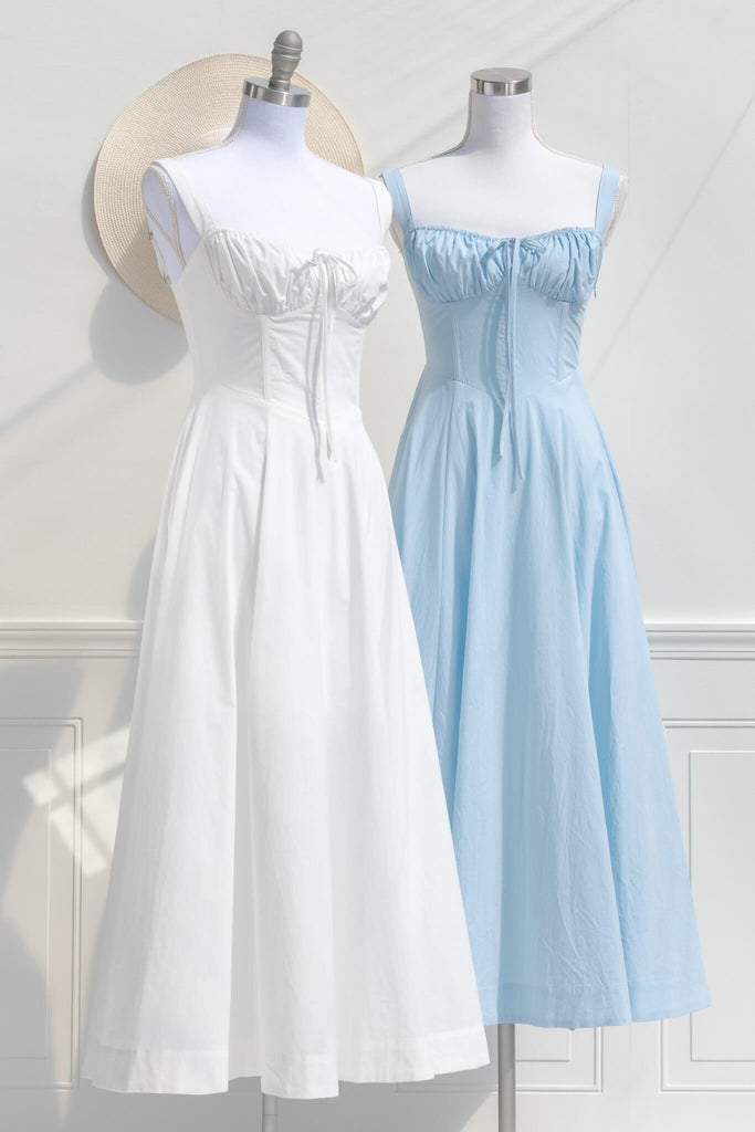 two beautiful cottagecore dress outfits, one white the other blue. Amantine boutique dresses. 
