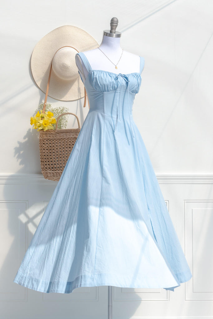 a cute long blue cottagecore style dress outfit with flowers. amantine boutique dresses.