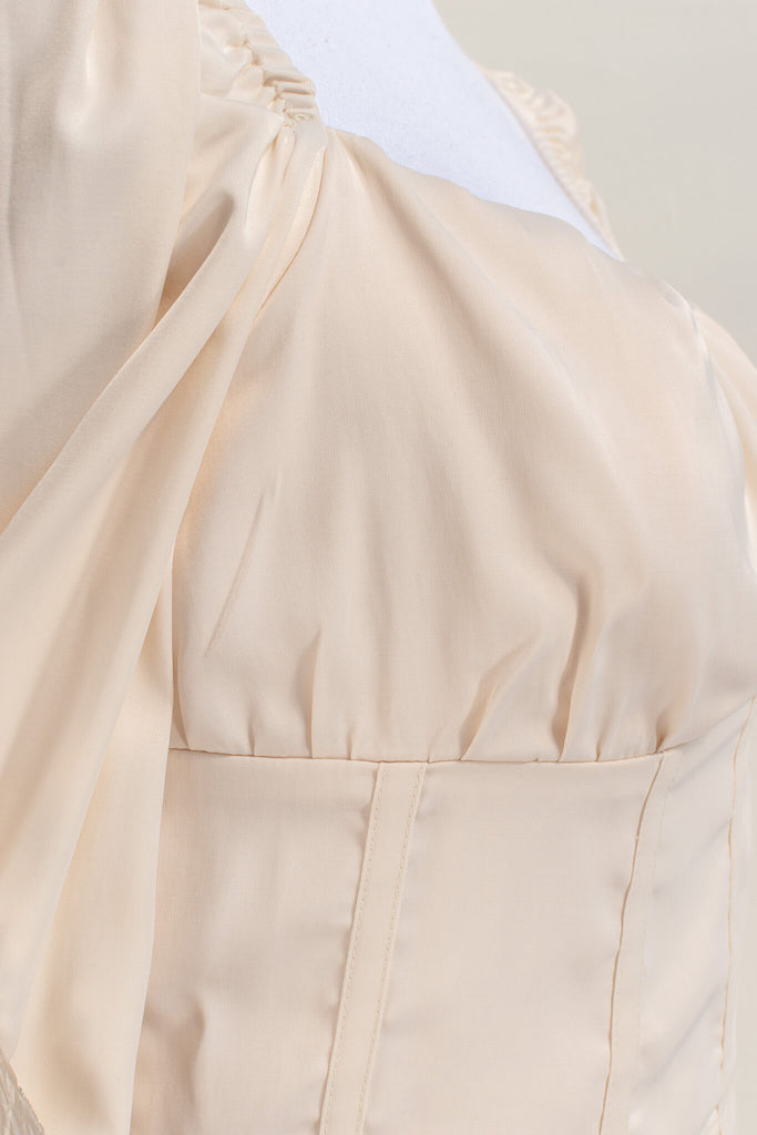 cottagecore outfits - a feminine top with long sleeves, bodice, and square neckline. up close fabric view. amantine. 