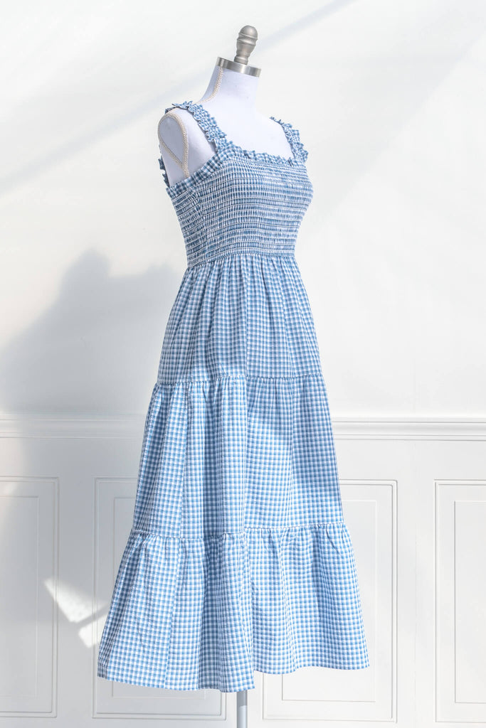 boutique dresses in a cottagecore outfit style. a blue and white gingham picnic dress with straps. side simple view. amantine. 