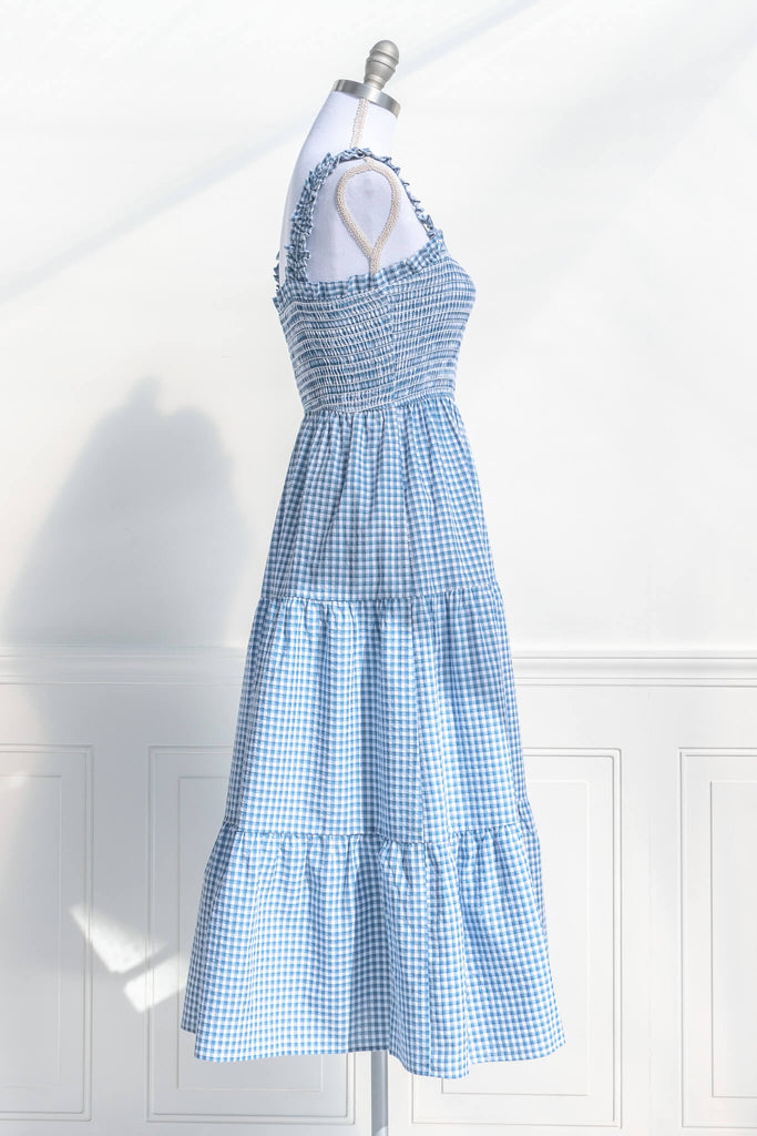 boutique dresses in a cottagecore outfit style. a blue and white gingham picnic dress with straps. side 3 view. amantine. 
