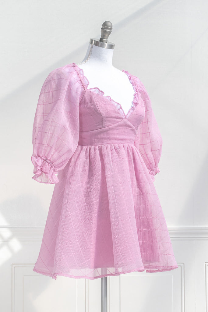 pink dresses. a puff sleeve french and feminine style sweetheart neckline pink dress. quarter side view. 