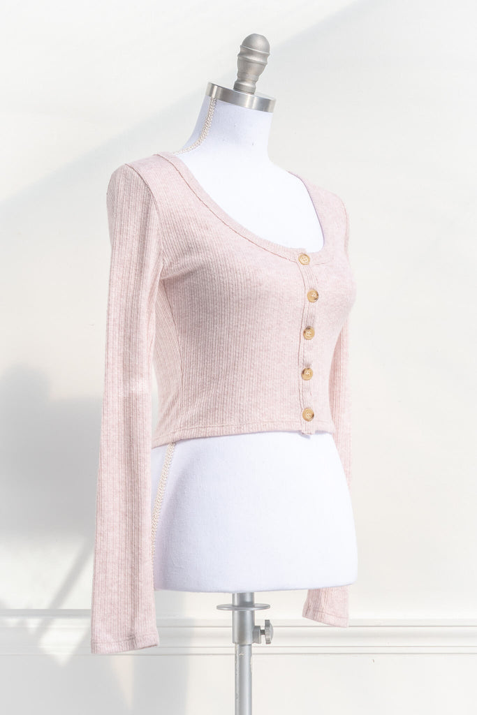 cottagecore outfits - a pink button down cardigan for spring. cottage core style. quarter side view. amantine. 