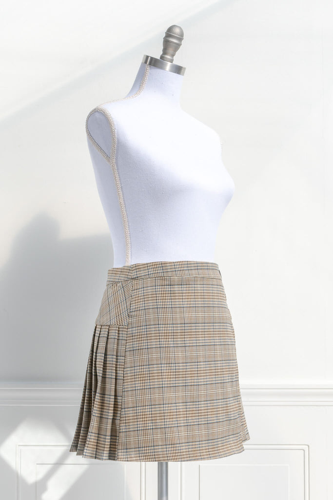 short skirts. a short skirt in light brown plaid. wrap around style. feminine short skirts. box pleat view. amantine.