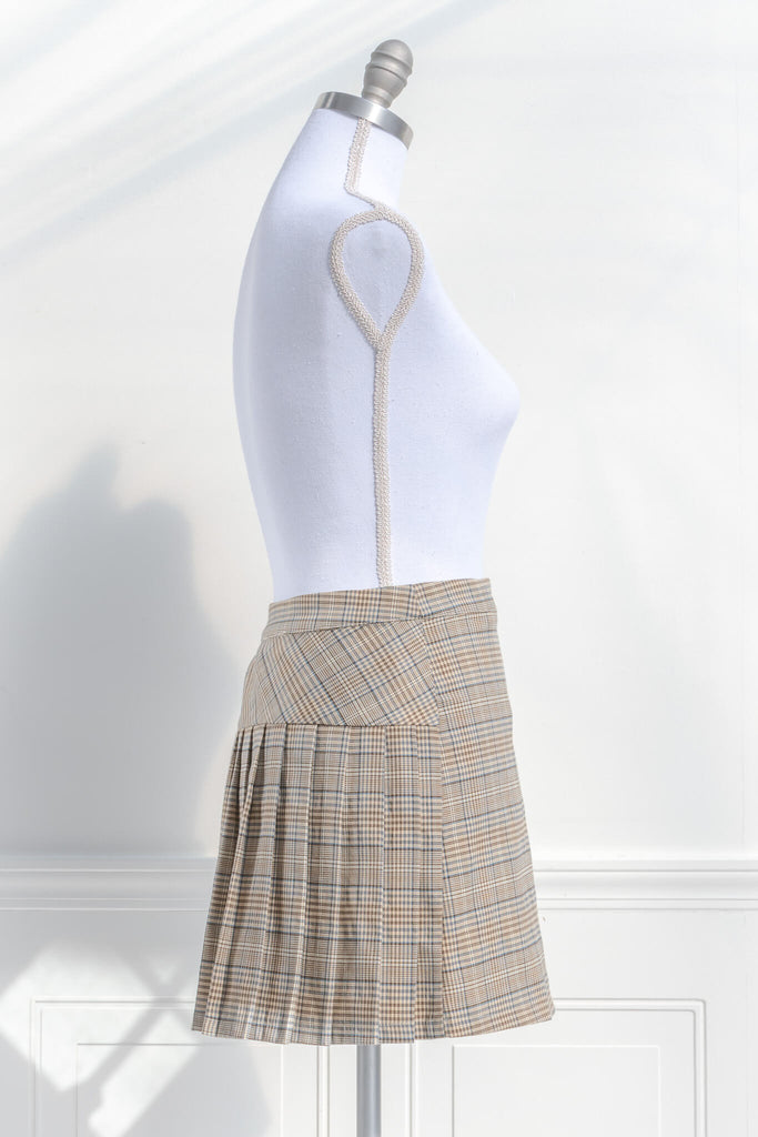 short skirts. a short skirt in light brown plaid. wrap around style. feminine short skirts. side view. amantine.