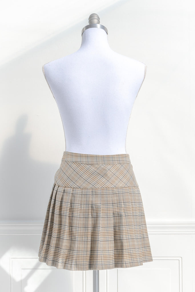 short skirts. a short skirt in light brown plaid. wrap around style. feminine short skirts. back view. amantine.