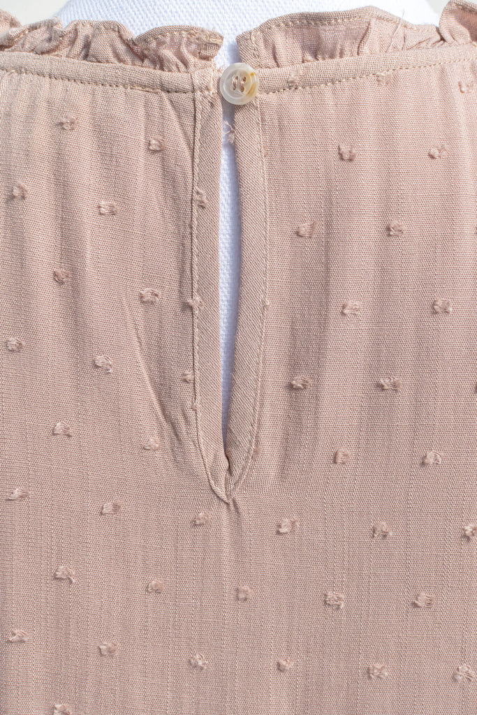 feminine tops for romantic outfits. a french girl style feminine top in taupe color. fabric up close view. 