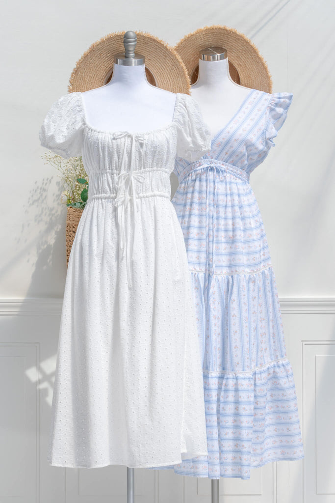 two cottagecore dresses styled in a feminine french girl style fashion. one white, the other blue. 