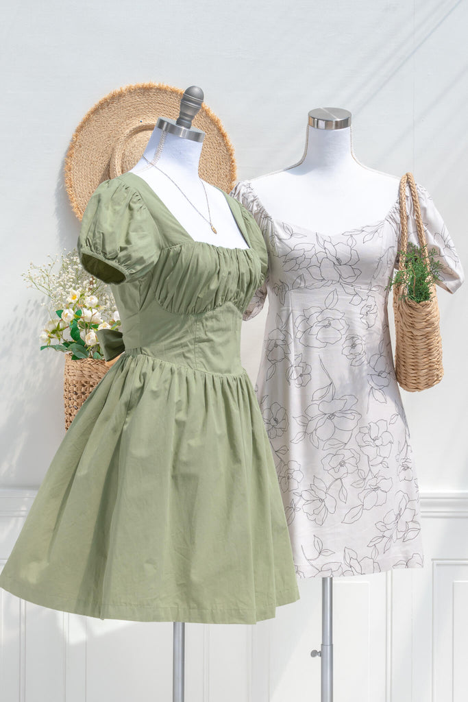 two cottagecore dresses one green the other beige with graphic floral print. 
