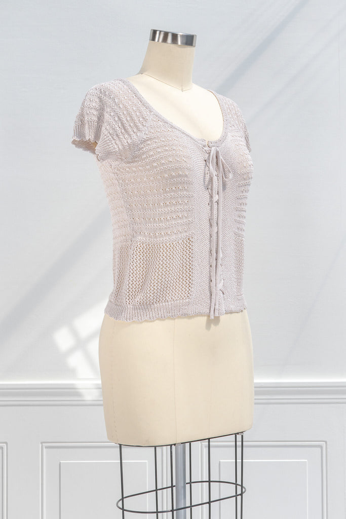 pink clothes - a feminine top with a corset tie front detail and crochet fabric. quarter view. 