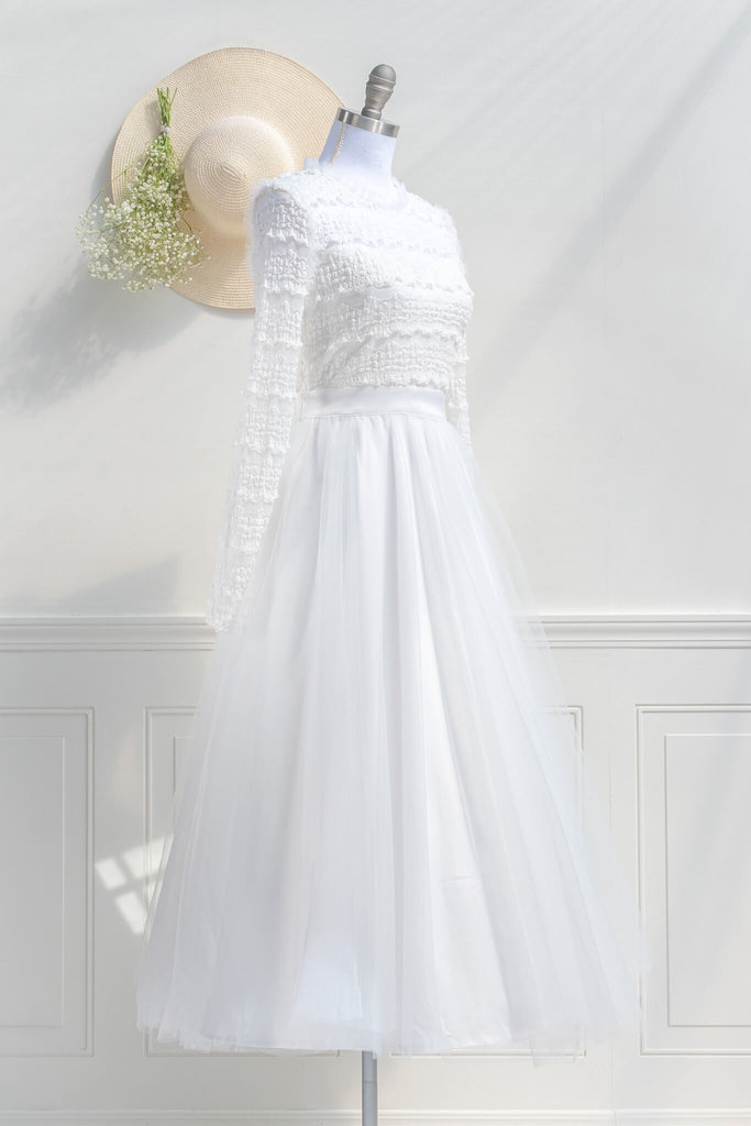 cottagecore bridal dress - a modest white long sleeve long skirt dress. feminine and french style boutique dresses. quarter view. amantine.