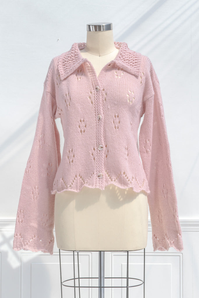 pink clothes - a pink button down cardigan with an oversized colar and oversized sleeves. feminine pink clothes. front view. 