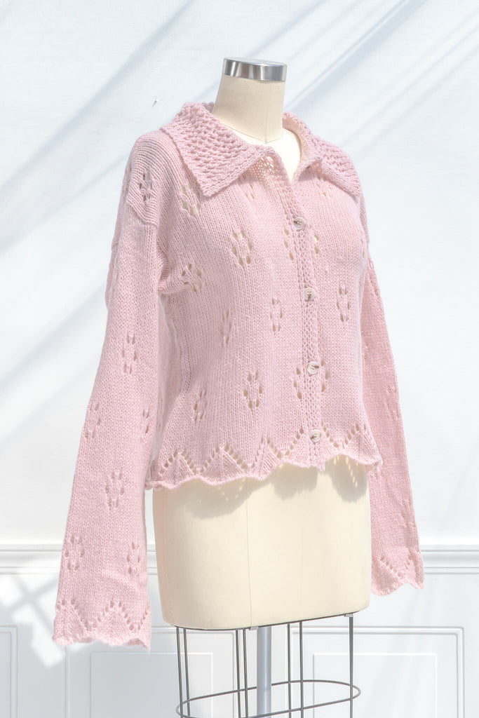 pink clothes - a pink button down cardigan with an oversized colar and oversized sleeves. feminine pink clothes. quarter view. 