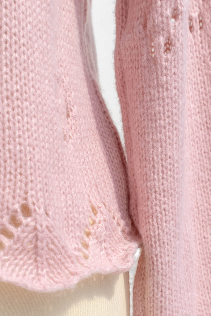 pink clothes - a pink button down cardigan with an oversized colar and oversized sleeves. feminine pink clothes. up close knit fabric view. 