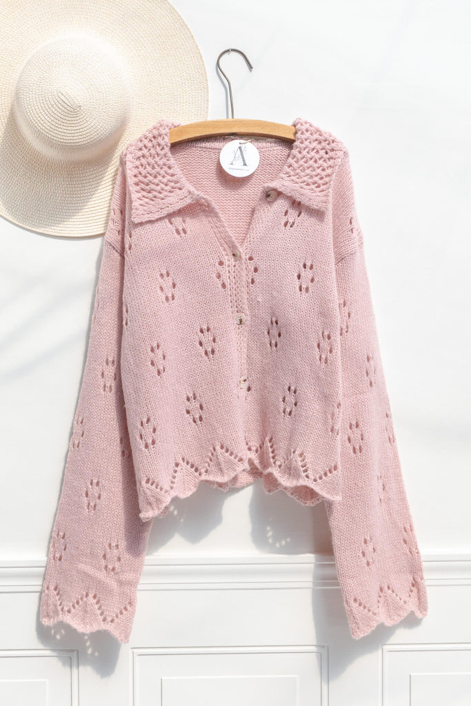 pink clothes - a pink button down cardigan with an oversized colar and oversized sleeves. feminine pink clothes. on hanger view. 