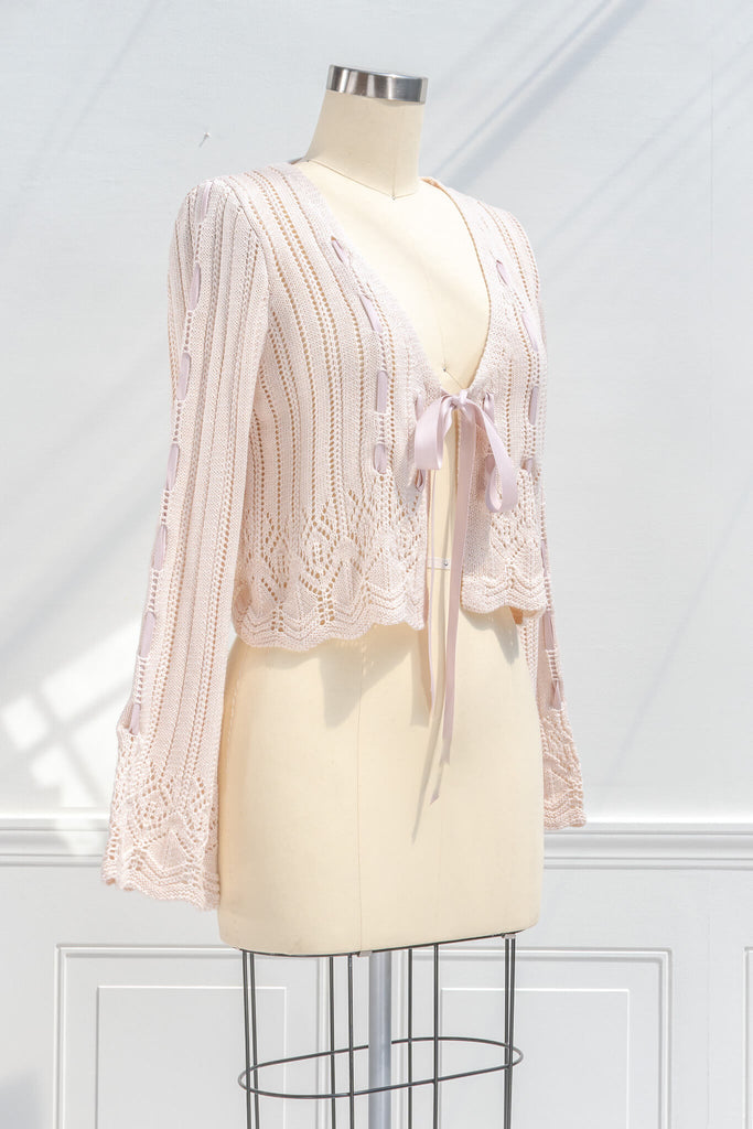 pink outfits - a beautiful and unique front tie cardigan with oversized sleeves and delicate knit details. quarter view. amantine. 