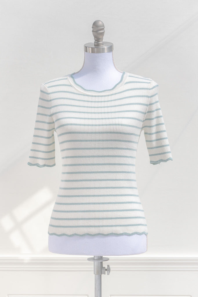 feminine french style tops - a french striped sweater top with 3/4 sleeves and scalloped edges on neckline, sleeves, and hem. cottagecore outfit. front view. amantine. 