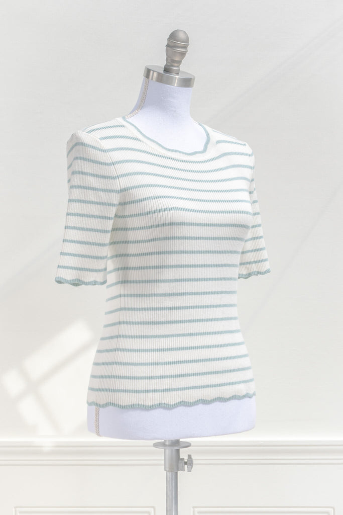 feminine french style tops - a french striped sweater top with 3/4 sleeves and scalloped edges on neckline, sleeves, and hem. cottagecore outfit. quarter view. amantine. 