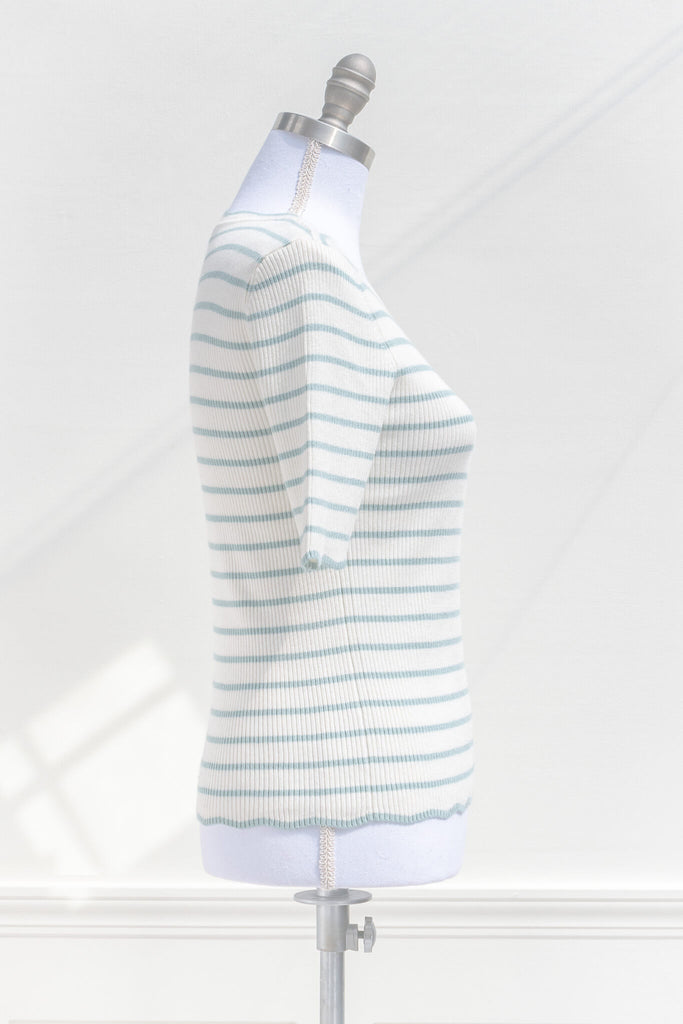 feminine french style tops - a french striped sweater top with 3/4 sleeves and scalloped edges on neckline, sleeves, and hem. cottagecore outfit. side view. amantine. 