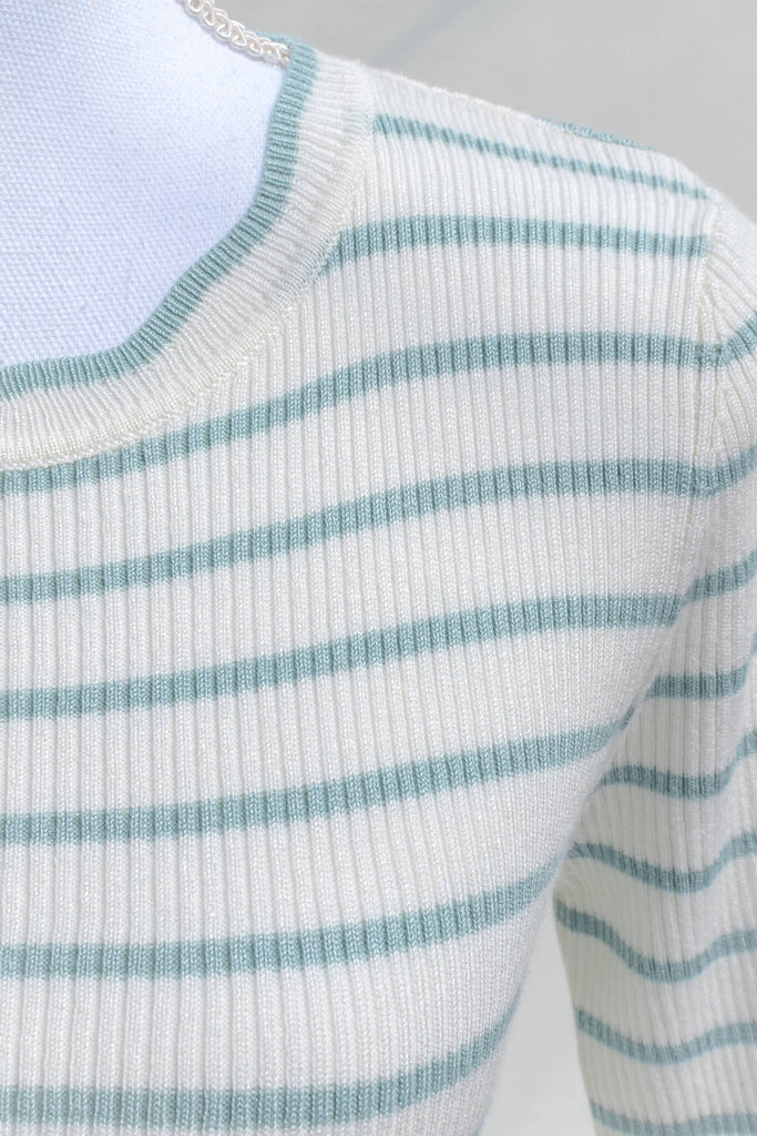 feminine french style tops - a french striped sweater top with 3/4 sleeves and scalloped edges on neckline, sleeves, and hem. cottagecore outfit. up close fabric view. amantine. 