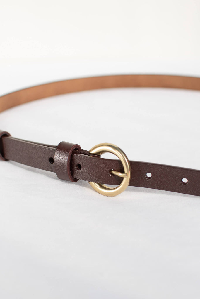 feminine accessories - a thin classic leather belt. 