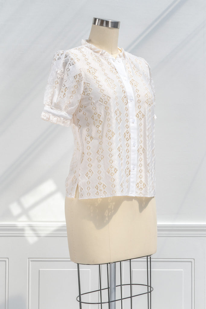feminine blouses for work - a cottagecore inspired women's blouse with buttondown front, ruffle neck, short sleeves and lace detail. quarter view. amantine.