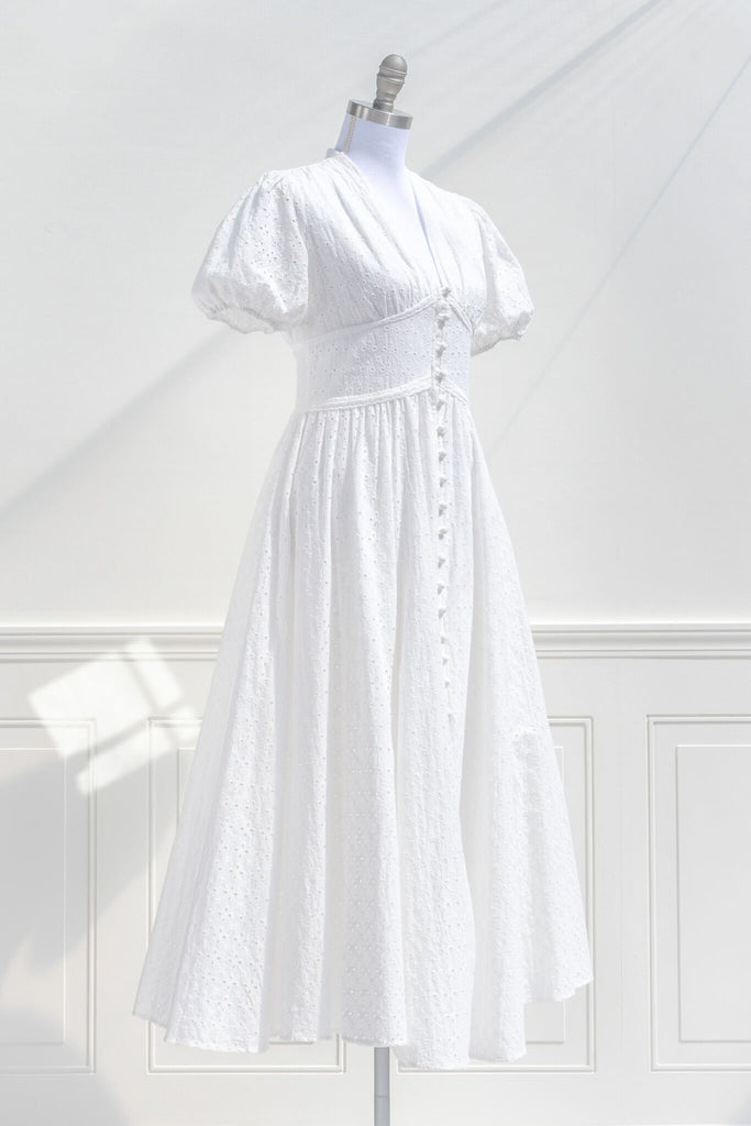 boutique cottagecore dresses - a lovely white dress with button-down feature, and puff sleeves. quarter side view. amantine.