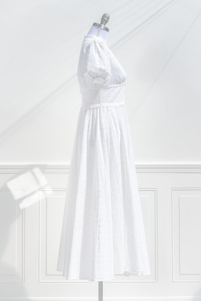 boutique cottagecore dresses - a lovely white dress with button-down feature, and puff sleeves. side view. amantine.