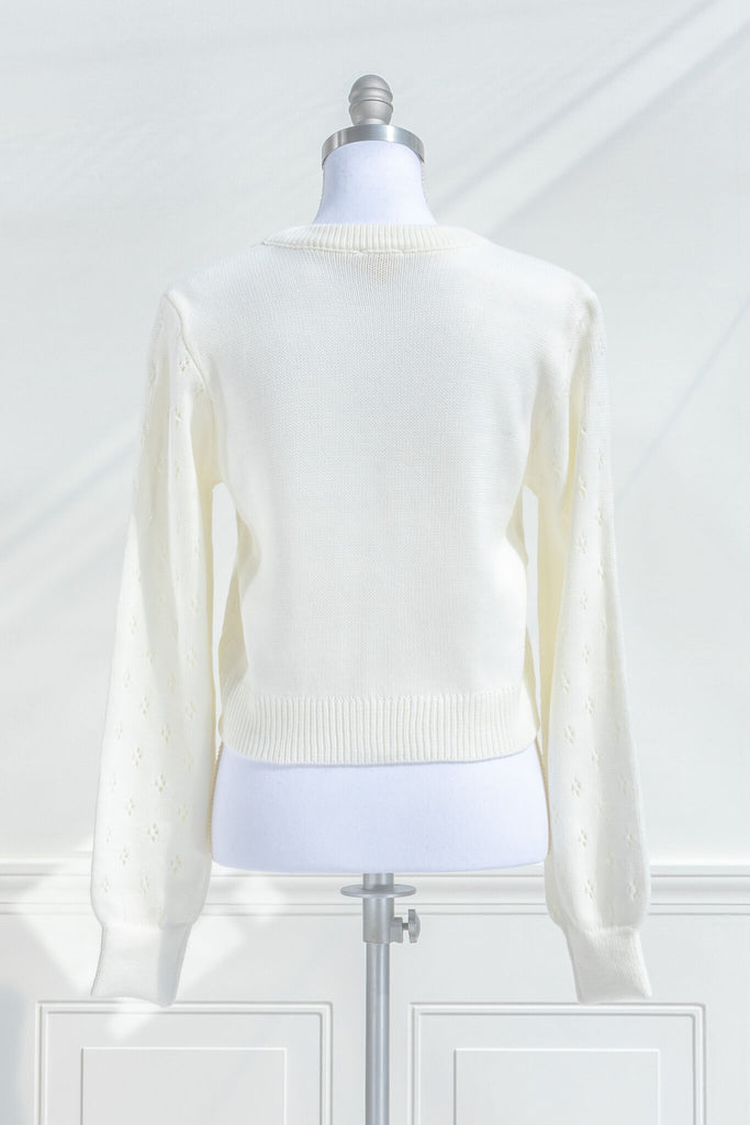 feminine tops - a french style cardigan sweater for spring. cream knit, button front, v neck, heart weave detail. back view. amantine. 