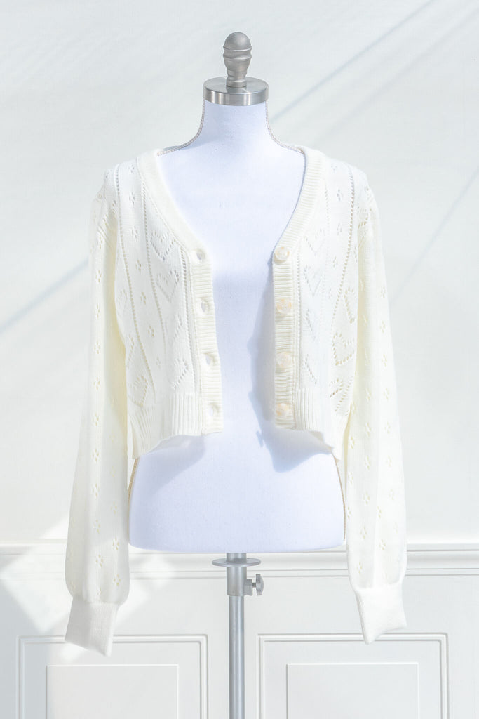 feminine tops - a french style cardigan sweater for spring. cream knit, button front, v neck, heart weave detail. open button view. amantine. 