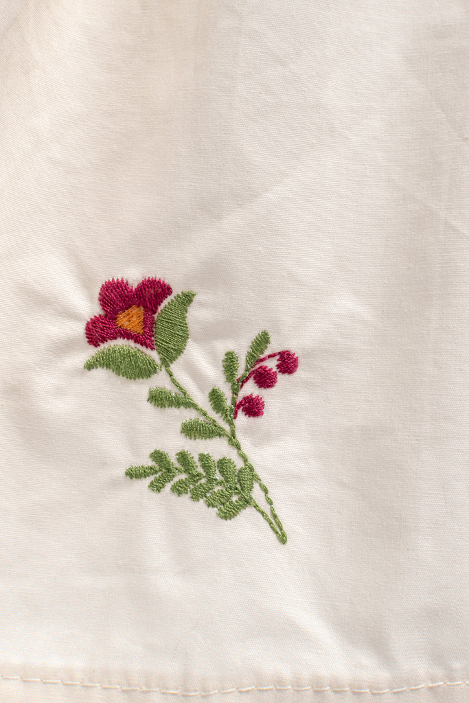 flower embroidery detail on cottage core dress. 