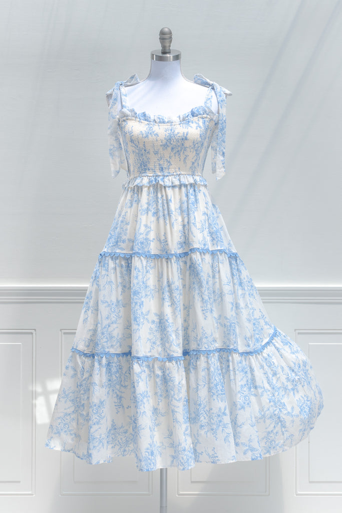 cottagecore style dresses for summer - a cute boutique dress in toile white and light blue print. front view. amantine dresses. 