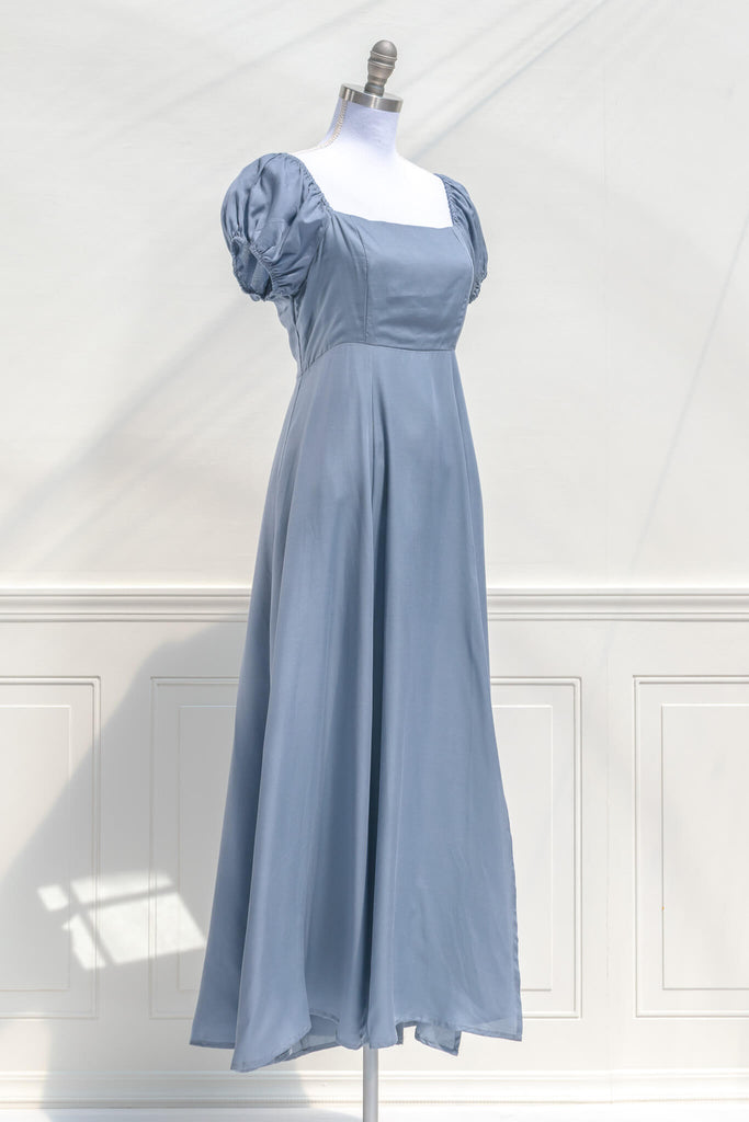 cottagecore dresses - a french inspired feminine dress in light blue, with puff sleeves, a line skirt, and high waistline - quarter view. amantine.