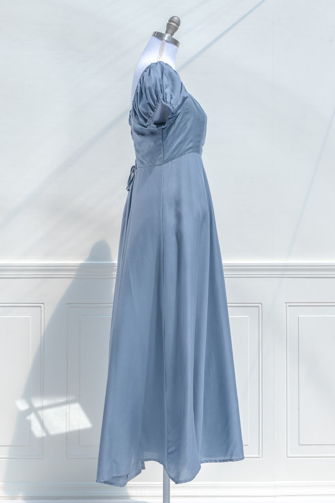 cottagecore dresses - a french inspired feminine dress in light blue, with puff sleeves, a line skirt, and high waistline - side view. amantine.