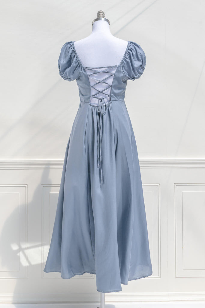 cottagecore dresses - a french inspired feminine dress in light blue, with puff sleeves, a line skirt, and high waistline - back view. amantine.