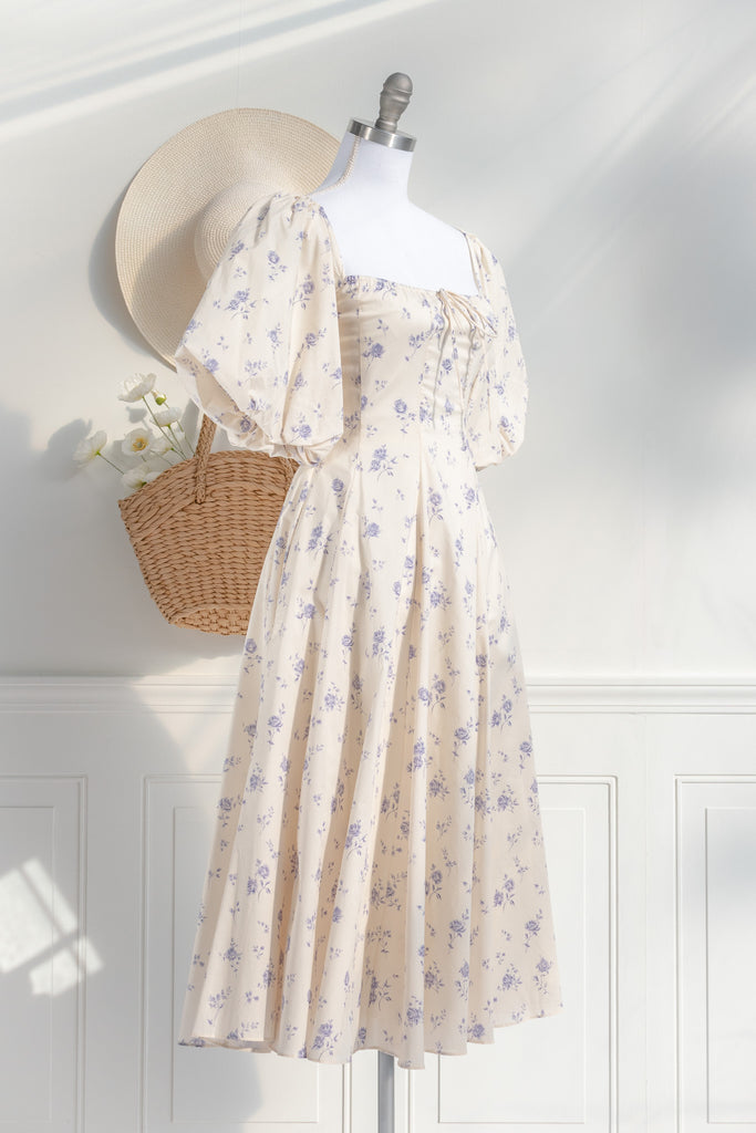 cottagecore dress - this dress is a flowing, romantic garment characterized by soft hues and delicate details that inspire feelings of nostalgia and whimsy. These dresses draw inspiration from the idyllic charm of life in a quaint, rural cottage from a bygone era as well as french country cottage charm. side view. 