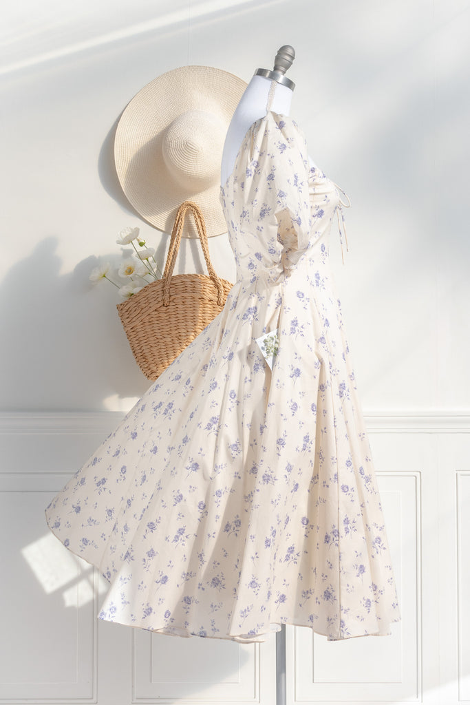 cottagecore dress - this dress is a flowing, romantic garment characterized by soft hues and delicate details that inspire feelings of nostalgia and whimsy. These dresses draw inspiration from the idyllic charm of life in a quaint, rural cottage from a bygone era as well as french country cottage charm. side view. 