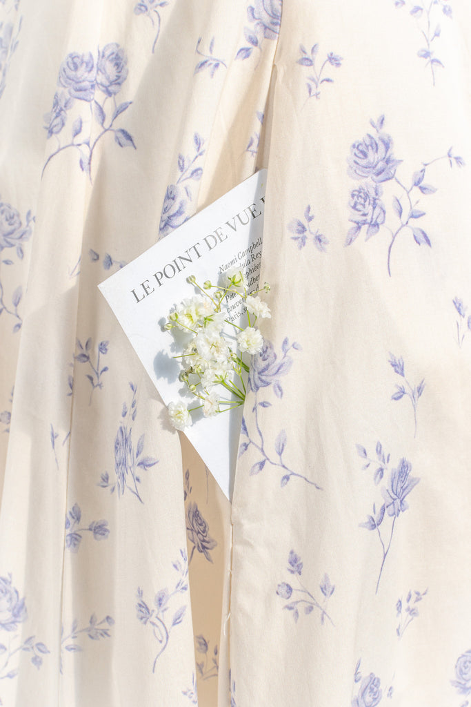 cottagecore dress - this dress is a flowing, romantic garment characterized by soft hues and delicate details that inspire feelings of nostalgia and whimsy. These dresses draw inspiration from the idyllic charm of life in a quaint, rural cottage from a bygone era as well as french country cottage charm. up close view of pocket detail. 